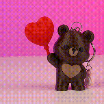 Osito llavero sosteniendo un globo rojo corazón